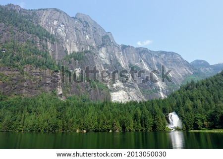 An incredible view of princess louisa inlet and chatterbox falls, with a huge waterfall and giant cliffs in the background, an incredible boating destination, on the sunshine coast, B.C., Canada