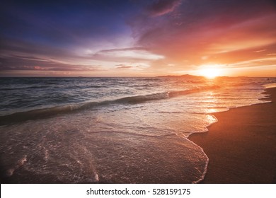 Incredibly beautiful sunset on the beach in Thailand. Sun, sky, sea, waves and sand. A holiday by the sea
