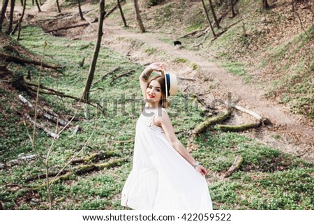 incredibly person goes on a forest glade and looks at the photographer