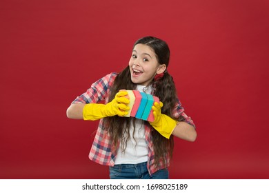 Inculcate cleanliness. Cleaning with sponge. Cleaning supplies. Girl rubber gloves for cleaning hold colorful sponges. Cleaning could be fun. Housekeeping duties. Wash dishes. Turn into game. - Shutterstock ID 1698025189
