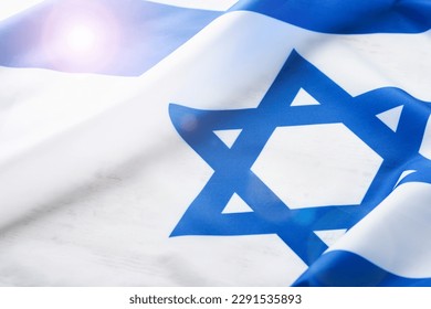 Independence Day of Israel. National Israel flag with star of David over white wooden background. Close up. National flag with place for text. - Shutterstock ID 2291535893