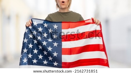 independence day, patriotic and human rights concept - woman with flag of united states of america protesting on demonstration over city street background
