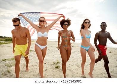 independence day, summer holidays and people concept - group of happy friends with american flag on beach celebrating 4th of july - Powered by Shutterstock