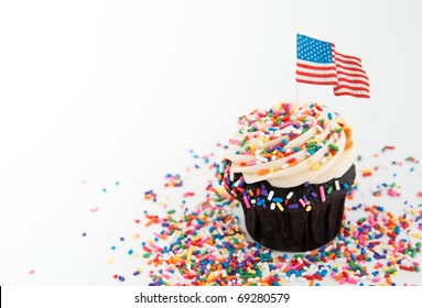 Independence Day Themed Cupcake With Lots Of Red, White And Blue  Sprinkles Plus US Flag