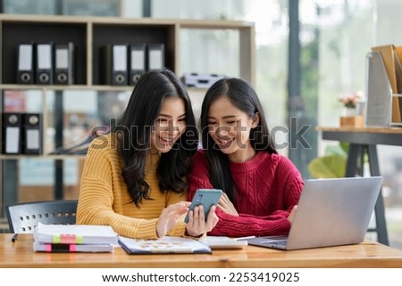 Independent Asian woman Have an idea and work in the office Confident in smart casual wear. Ready to take pictures with a happy lollipop mobile phone.