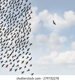 Independent Thinker Concept And New Leadership Concept Or Individuality As A Group Of Flying Birds With One Individual Bird Going In The Opposite Direction As A Business Icon For Innovative Thinking.