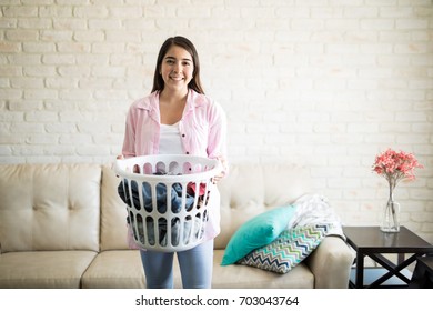 Independent young woman doing chores in her new apartment and enjoying being by herself