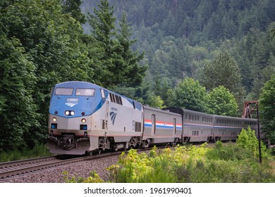 Index, WA, USA - July 10, 2019; Amtrak's Empire Builder overnight passenger train from Chicago to Seattle passes through Index Washington, in the Cascade Mountains, on the final leg of its journey