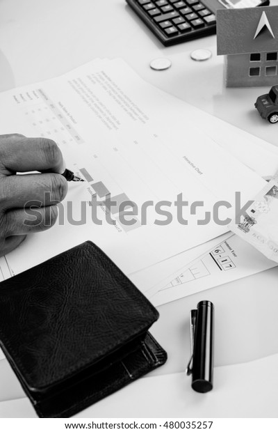 India and accounting concept showing
accountant working on Income tax forms or on budget planning with
currency notes, calculator and house/car 3d
Models