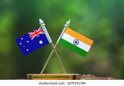 India And Australia Small Flag With Blur Green Background