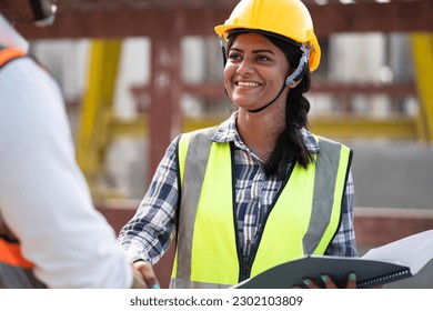 India engineer woman with document handshake Asia engineer man at precast site work	 - Shutterstock ID 2302103809