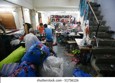 INDIA - FEB 26: Textile Workers In A Small Factory In Old Delh On February 26, 2008 In Delhi, India. Many Small Factories Provide The West With Their Clothes.