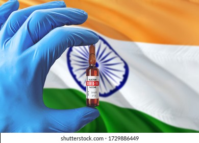 India Flag With Coronavirus Covid-19 Concept. Doctor With Blue Protection Medical Gloves Holding A Vaccine Bottle. Epidemic Virus, Cov-19, Corona Virus Outbreaking.