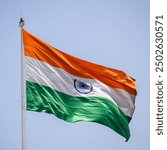 India flag flying high at Connaught Place with pride in blue sky, India flag fluttering, Indian Flag on Independence Day and Republic Day of India, tilt up shot, Waving Indian flag, Har Ghar Tiranga