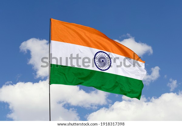 India flag isolated\
on the blue sky with clipping path. close up waving flag of India.\
flag symbols of India.