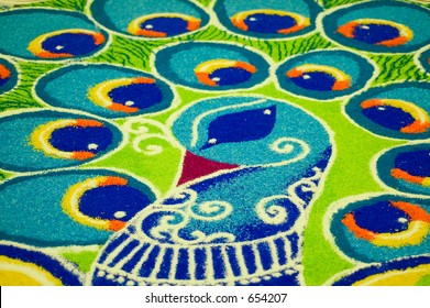 India Folk Art (rangoli) Of A Peacock Using Colored Rice Put Together On The Floor