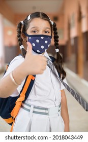 India Girl Wearing Face Mask Showing Thumb Up With Dressed In School Uniform And Look At Camera