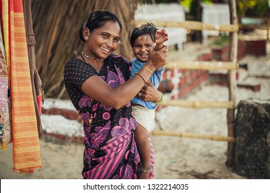 India, Goa, the village of Benaulim  - November 15, 2012: Unidentified Indian woman and baby in her arms are smiling with very good mood. A mother and her child. 