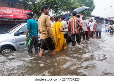 India, Maharashtra, Mumbai, July 14, 2009: People Walk Through A Flooded Street Due To Heavy Rains At Kurla.