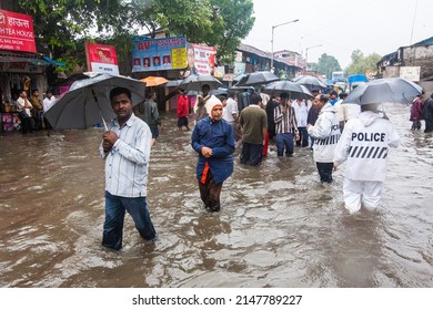 India, Maharashtra, Mumbai, July 14, 2009: People Walk Through A Flooded Street Due To Heavy Rains At Kurla.