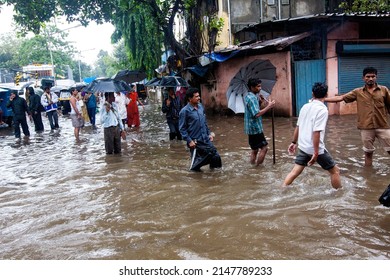 India, Maharashtra, Mumbai, July 14, 2009: People Walk Through A Flooded Street Due To Heavy Rains At Kurla.