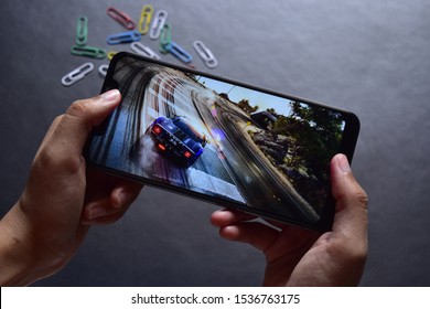 India, New Delhi,  October 19, 2019: Playing Car Race Game On Android Mobile Phone