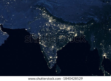 India at night, view of city lights showing human activity in India from space. Part of South Asia on world dark map in global satellite picture. Tech theme. Elements of this image furnished by NASA.