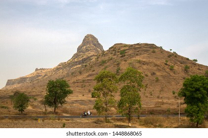 India, Pune - April 6, 2018: Dry hills in the area of the Deccan plateau, and the highway in front of the mountain outliers, India