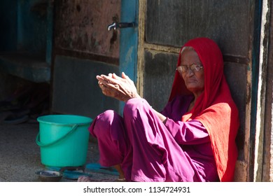 India, Pushkar-March 4, 2018: Poor Old Woman With A Decent Expression In Red Head Wrap, Piercing The Nostrils, Worthy Old Age