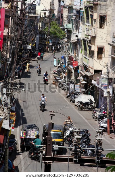 India, Udaipur - March 25, 2018: One of\
the main arteries of the city. Draws attention to the abundance of\
motorcycles and messy electrical\
wires