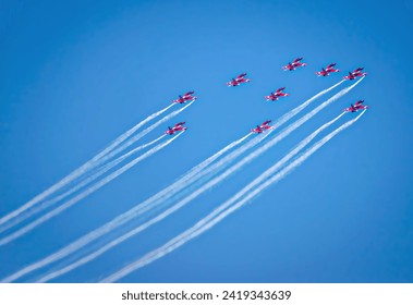 Indian Air Force's Surya Kiran Aerobatic Team planes performing maneuvers during Mumbai Air Show 2024. - Powered by Shutterstock