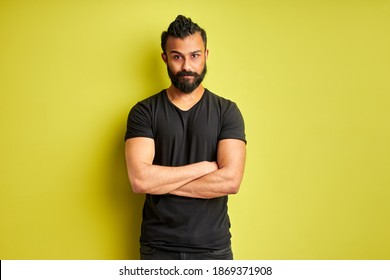 Indian Arabic Indian Man Is Skeptic And Nervous, Disapproving Expression On Face With Crossed Arms Isolated On Green Background, Negative Person