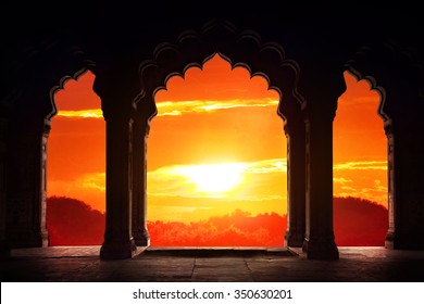 Indian arch silhouette in old temple at dramatic orange sunset sky background. Free space for text - Powered by Shutterstock