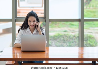 Indian / Asian College Student With Laptop Computer, Talking Mobile Phone.