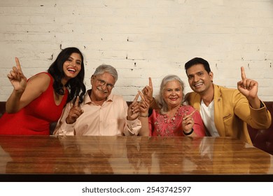 Indian asian family celebrating a birthday party at restaurant outdoors. Indian family fun together  - Powered by Shutterstock