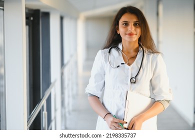 An Indian Asian Female Medical Doctor In A Hospital Office With Stethoscope.