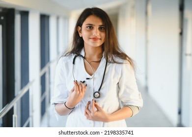 An Indian Asian Female Medical Doctor In A Hospital Office With Stethoscope.