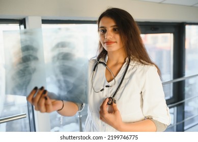 An Indian Asian Female Medical Doctor In A Hospital Office With Stethoscope.