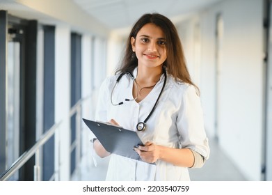 An Indian Asian Female Medical Doctor In A Hospital Office With Stethoscope.