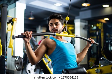 Indian Asian Handsome Man Working Out Or Exercising In The Gym - Health And Fitness Concept