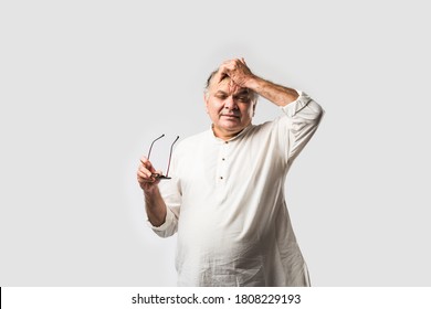 Indian asian old man having pain or ache in different body parts, sad expressions
