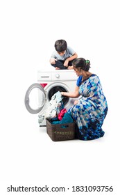 Indian Asian Pretty Housewife Washing Cloths In Washing Machine And Kids Watching