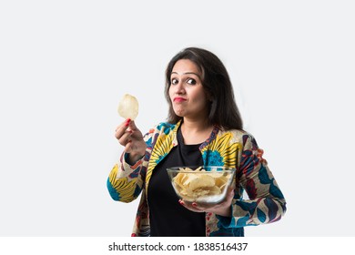 Indian Asian Pretty Young Woman Eating Potato Chips On White Background