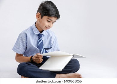 Indian / Asian School Boy With Note Book And Studying 