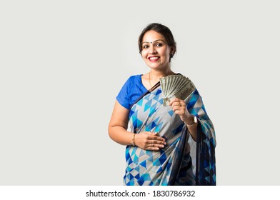 Indian Asian Woman In Sari Or Saree Showing Or Holding Paper Currency Notes Or Money Fan Against White Background