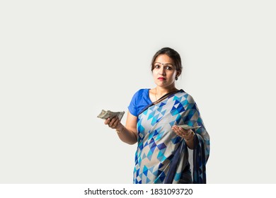 Indian Asian Woman In Sari Or Saree Showing Or Holding Paper Currency Notes Or Money Fan Against White Background