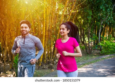 Indian asian young Couple jogging, running, exercising or stretching outdoors in park or nature - Shutterstock ID 1850151079