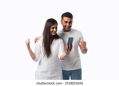 Indian Asian Young Couple Using Smartphone Against White Background