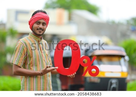 Indian auto driver showing zero percent board with his auto