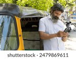 Indian auto driver using mobile phone